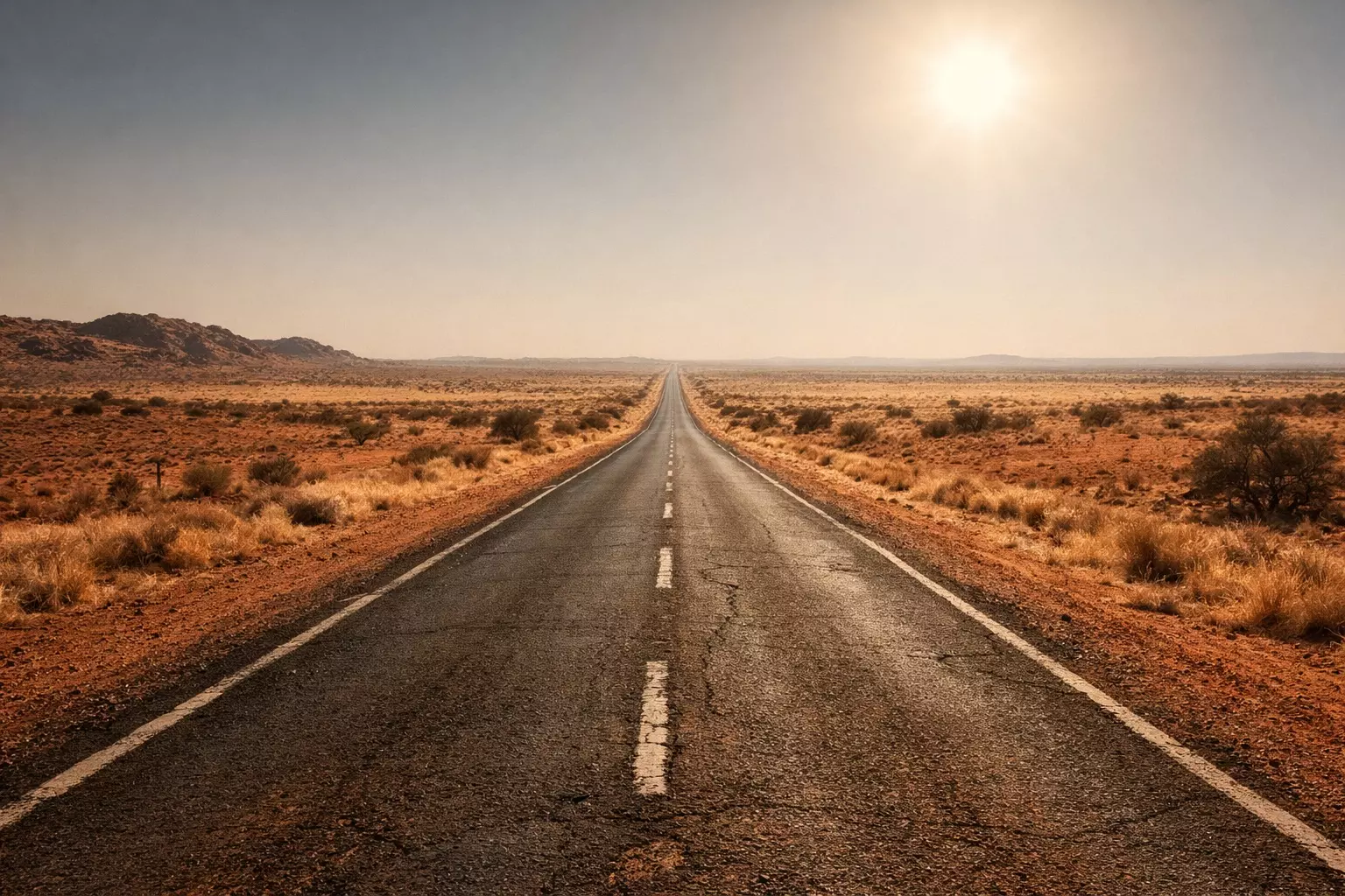 Carretera solitaria que atraviesa el desierto del outback australiano bajo un sol abrasador, símbolo del aislamiento y la tensión de la novela negra australiana.